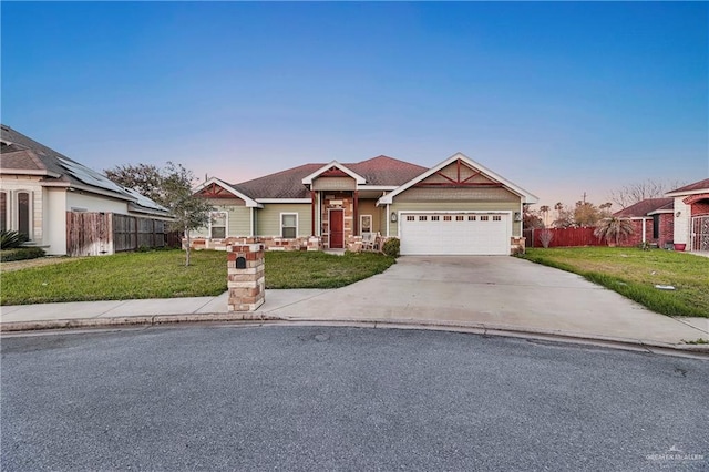 view of front of home featuring a lawn and a garage