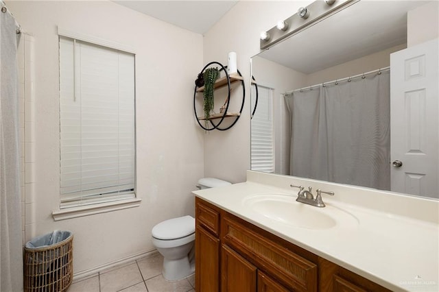 bathroom featuring tile patterned flooring, vanity, and toilet