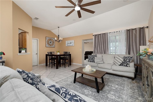 living room with light tile patterned floors, ceiling fan with notable chandelier, and vaulted ceiling