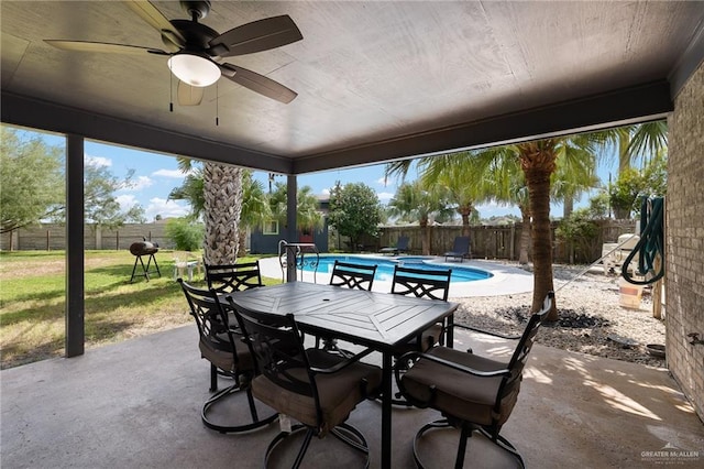 view of patio featuring a fenced in pool and ceiling fan