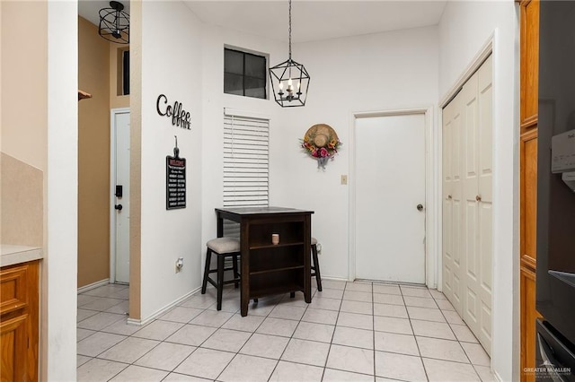 dining room featuring light tile patterned floors and a chandelier