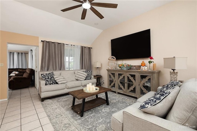 living room with tile patterned flooring, ceiling fan, and vaulted ceiling