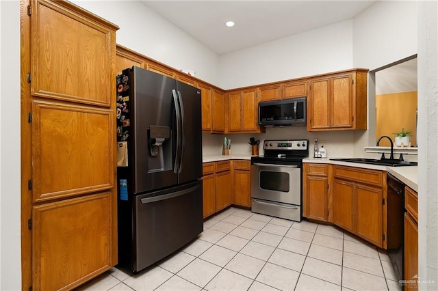 kitchen with light tile patterned floors, sink, and black appliances