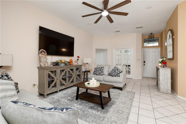 living room with ceiling fan and light tile patterned floors