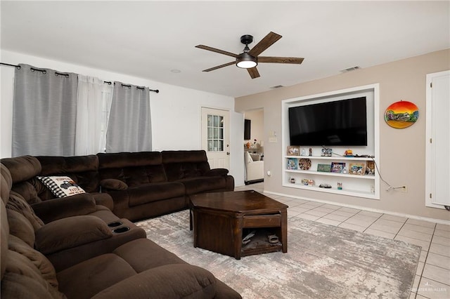 living room featuring light tile patterned floors and ceiling fan