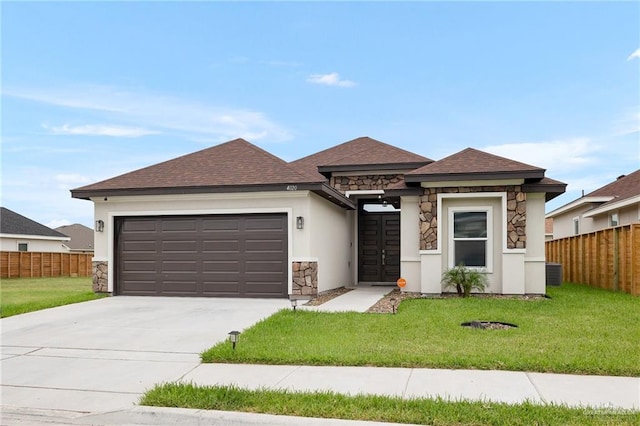 view of front of property featuring a front yard and a garage