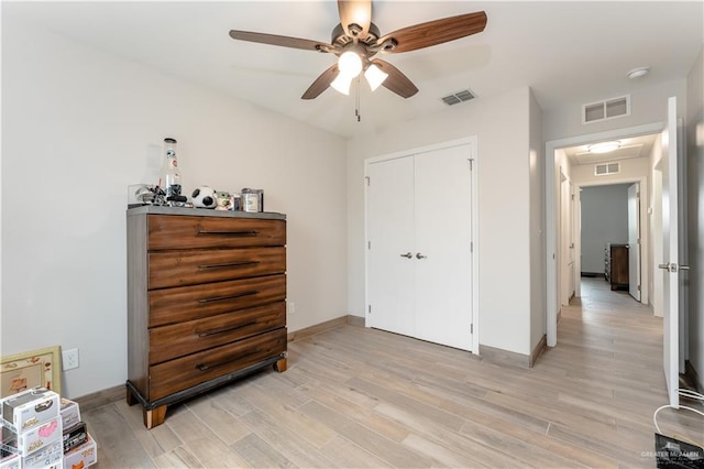 bedroom with ceiling fan, a closet, and light wood-type flooring