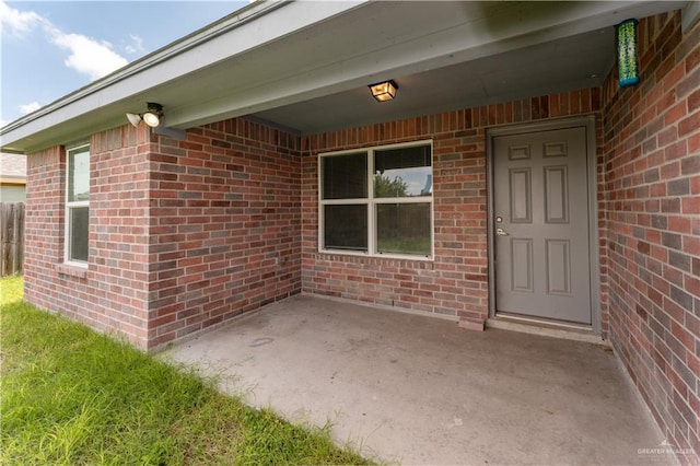 property entrance featuring a patio area