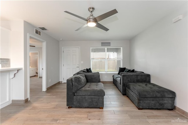 living room with ceiling fan and light hardwood / wood-style flooring