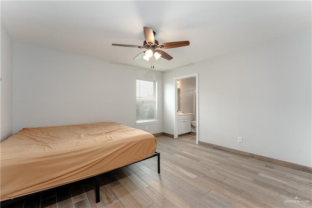 bedroom with ensuite bathroom, light hardwood / wood-style flooring, and ceiling fan