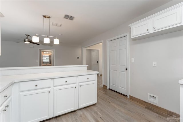 kitchen featuring white cabinetry, ceiling fan, decorative light fixtures, and light wood-type flooring