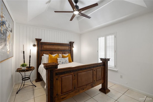 tiled bedroom with ceiling fan, lofted ceiling, and a tray ceiling