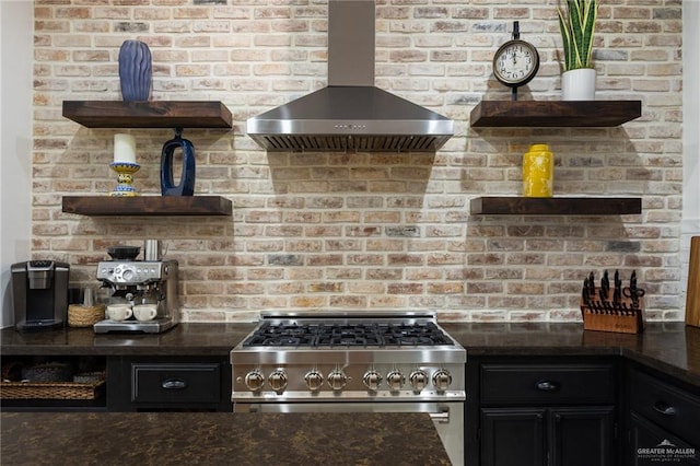 kitchen with brick wall, wall chimney range hood, and high end stainless steel range