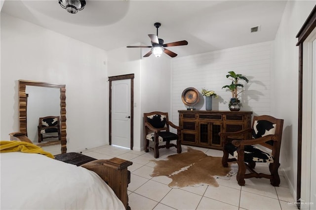 bedroom with ceiling fan and light tile patterned floors