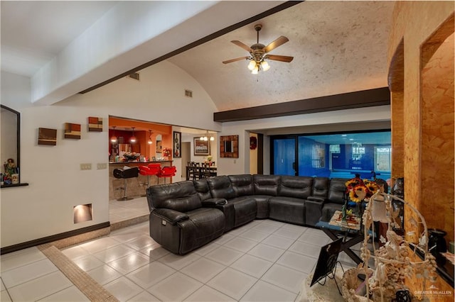 living room with vaulted ceiling with beams, ceiling fan, and light tile patterned floors