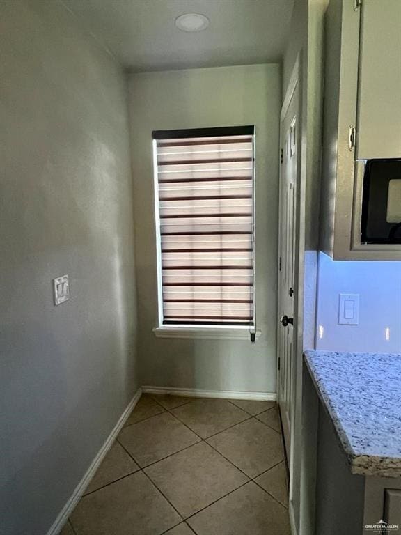 entryway with light tile patterned floors