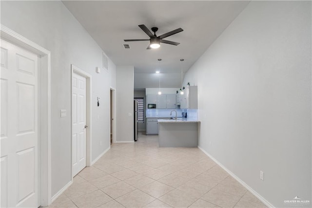 hall with light tile patterned floors