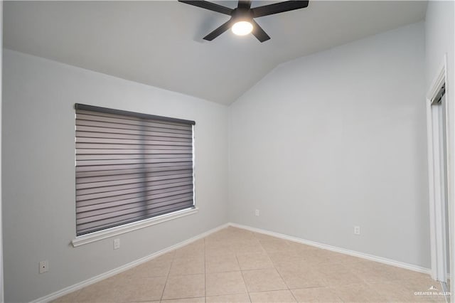 tiled spare room featuring ceiling fan and lofted ceiling