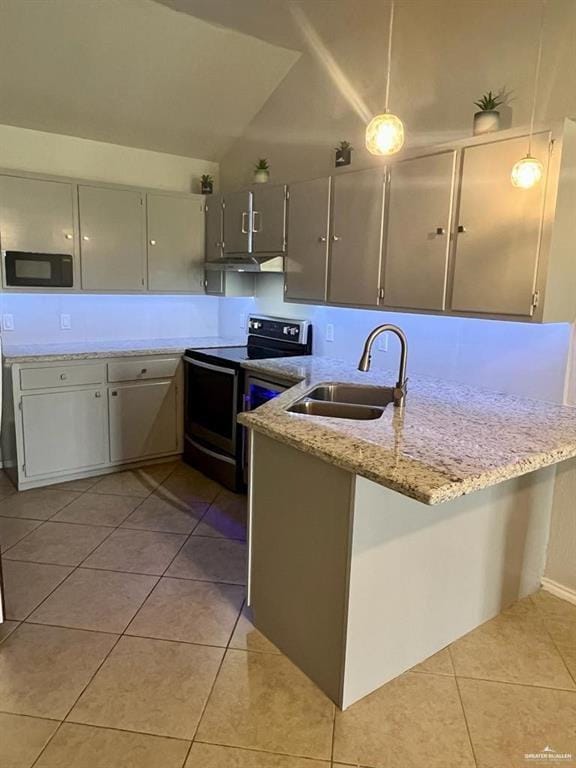 kitchen with kitchen peninsula, light stone counters, sink, electric range, and decorative light fixtures