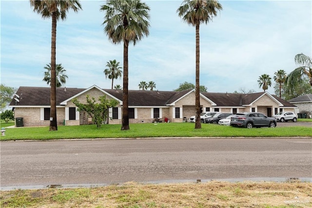 ranch-style home featuring a front yard