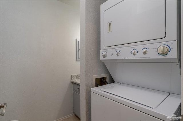 laundry room with stacked washing maching and dryer