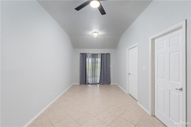 unfurnished room featuring ceiling fan, light tile patterned flooring, and lofted ceiling