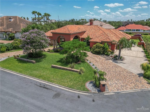 mediterranean / spanish-style home featuring a front lawn