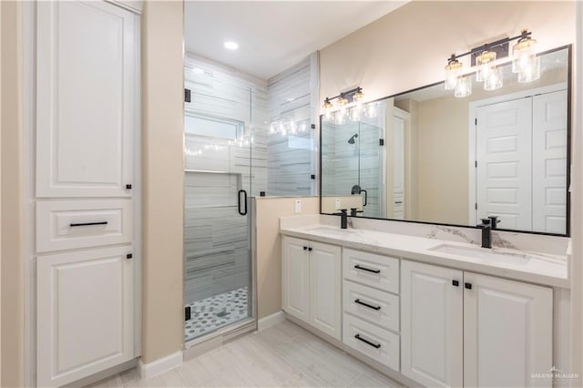 bathroom with vanity and a shower with shower door