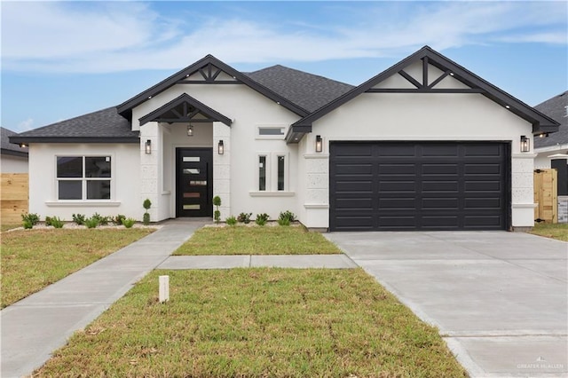 view of front of property featuring a front yard and a garage