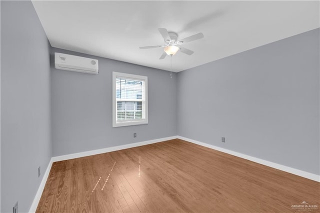 517 E Jones Ave, Pharr, TX 78577 - spare room featuring a wall mounted AC, wood finished floors, and ceiling fan