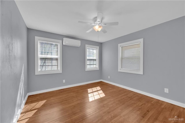 517 E Jones Ave, Pharr, TX 78577 - empty room featuring an AC wall unit, ceiling fan, and wood finished floors