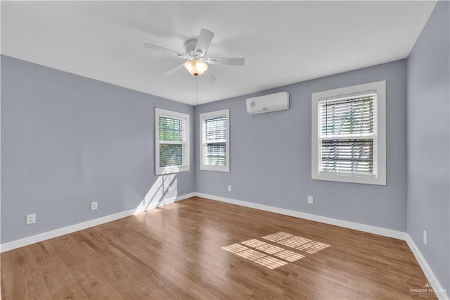 517 E Jones Ave, Pharr, TX 78577 - spare room featuring plenty of natural light, a wall mounted AC, ceiling fan, and wood finished floors