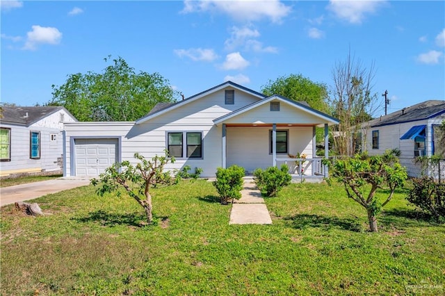 517 E Jones Ave, Pharr, TX 78577 - view of front of house with an attached garage, a porch, driveway, and a front yard