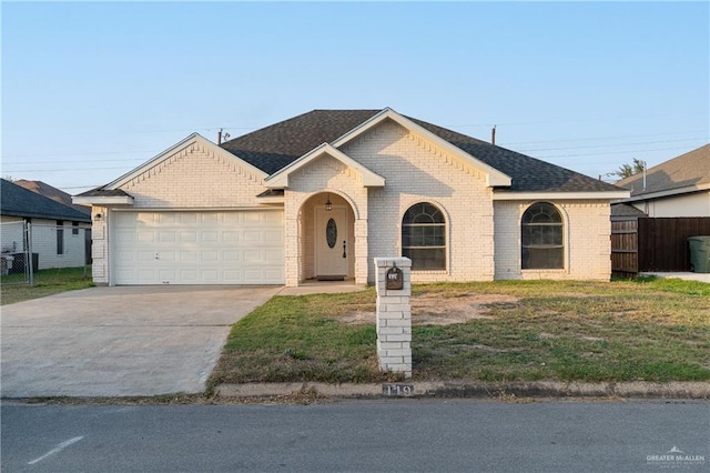 view of front of property with brick siding, a shingled roof, fence, a garage, and driveway