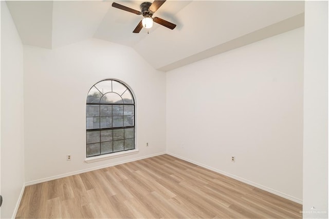 empty room featuring lofted ceiling, light wood finished floors, a ceiling fan, and baseboards