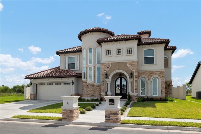 mediterranean / spanish home featuring a front yard, french doors, a garage, and central air condition unit