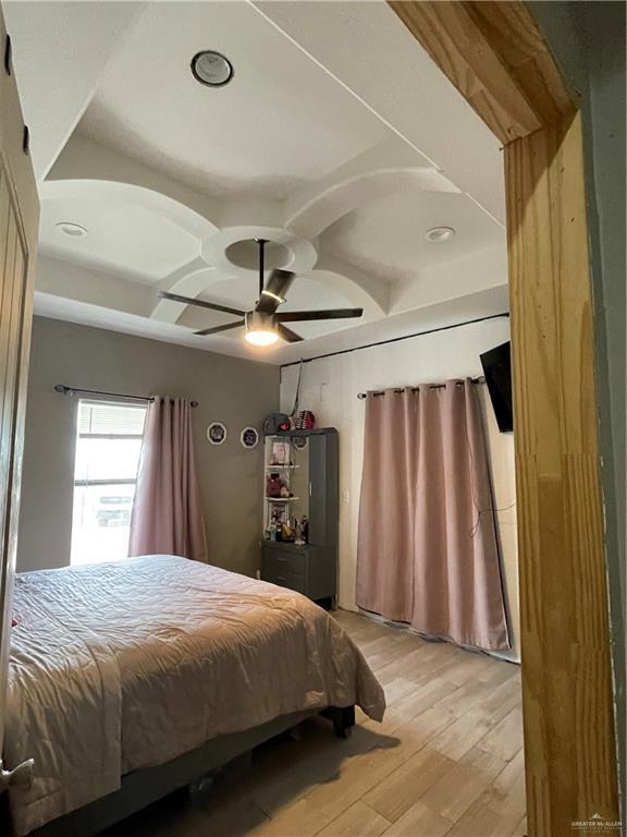 2205 Griffin Pass, Edinburg, TX 78542 - bedroom with light wood-style floors, a ceiling fan, and coffered ceiling