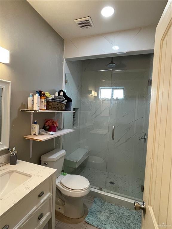 2205 Griffin Pass, Edinburg, TX 78542 - bathroom featuring toilet, a marble finish shower, and vanity