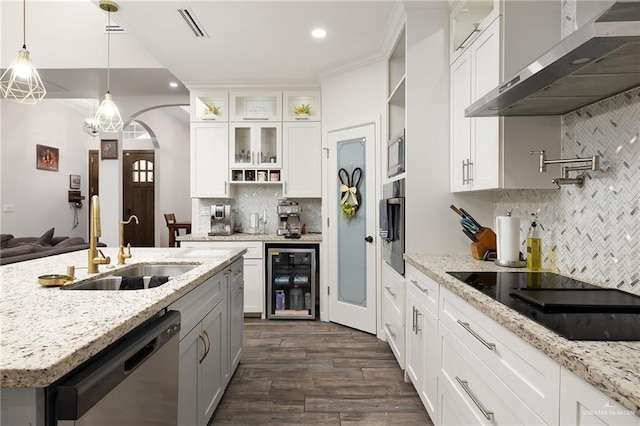 kitchen with wine cooler, white cabinetry, wall chimney range hood, appliances with stainless steel finishes, and glass insert cabinets