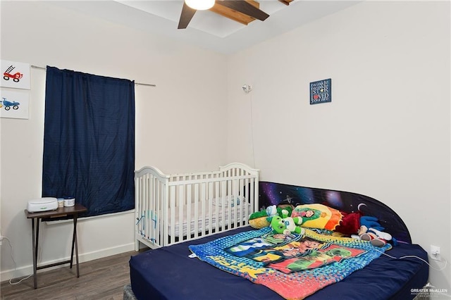 bedroom featuring ceiling fan, dark wood-type flooring, and baseboards