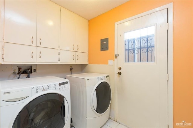 laundry area with cabinets, washer and clothes dryer, and light tile patterned flooring