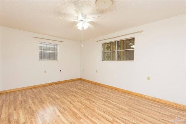 spare room with ceiling fan, light hardwood / wood-style floors, and a textured ceiling