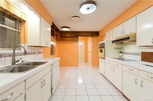 kitchen featuring white cabinets, white appliances, tile countertops, and sink