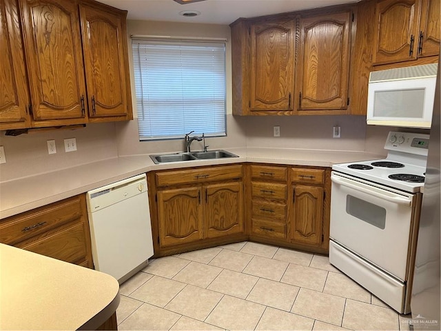 2711 Ashley Ct, Pharr, TX 78577 - kitchen featuring brown cabinets, white appliances, light countertops, and a sink