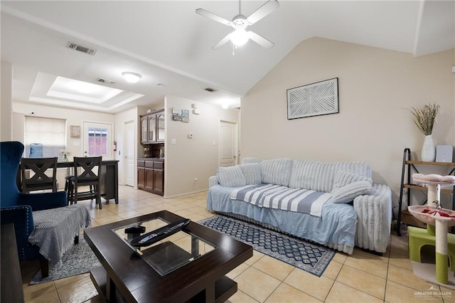 living room with vaulted ceiling, light tile patterned flooring, and visible vents