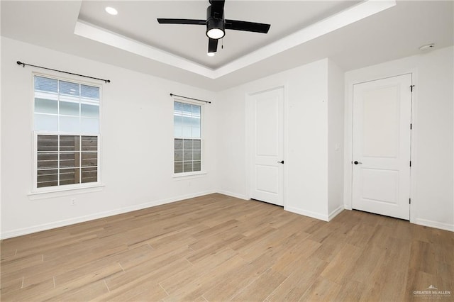 3515 Elevation Dr, Edinburg, TX 78542 - interior space with recessed lighting, a tray ceiling, a ceiling fan, light wood-style floors, and baseboards