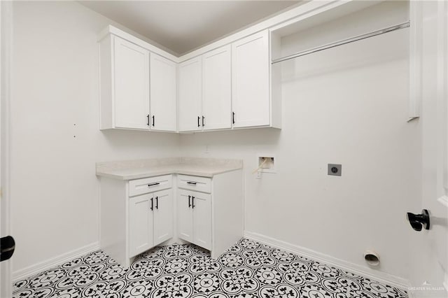 3515 Elevation Dr, Edinburg, TX 78542 - washroom with hookup for an electric dryer, light tile patterned flooring, baseboards, hookup for a washing machine, and cabinet space