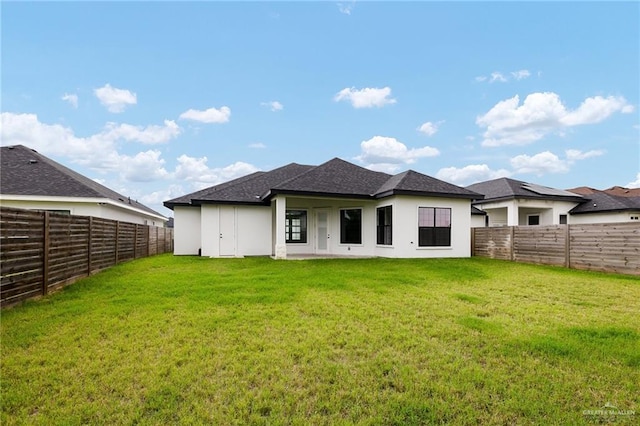 3515 Elevation Dr, Edinburg, TX 78542 - back of house with a lawn, a fenced backyard, and stucco siding