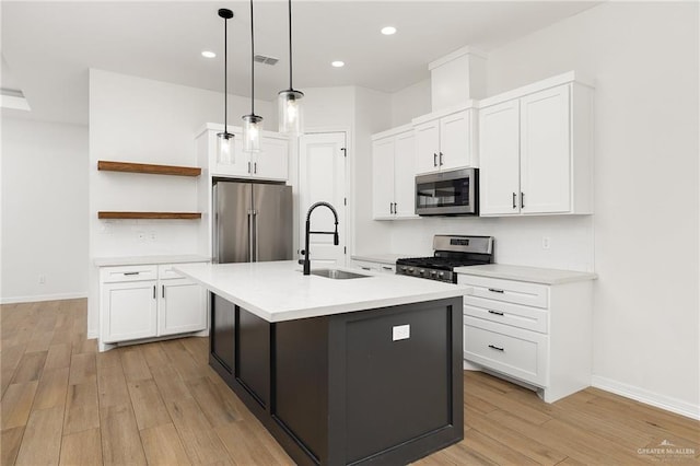 3515 Elevation Dr, Edinburg, TX 78542 - kitchen with open shelves, a sink, light wood-style floors, and appliances with stainless steel finishes