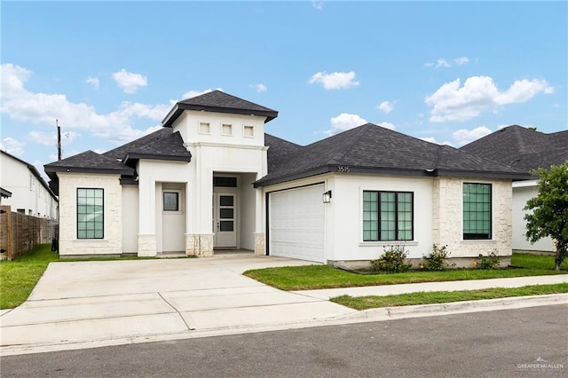 3515 Elevation Dr, Edinburg, TX 78542 - prairie-style house featuring roof with shingles, stone siding, concrete driveway, fence, and an attached garage